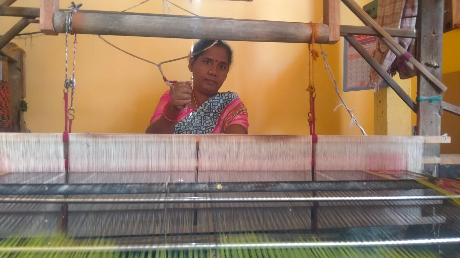 Traditional weaving process on a handloom